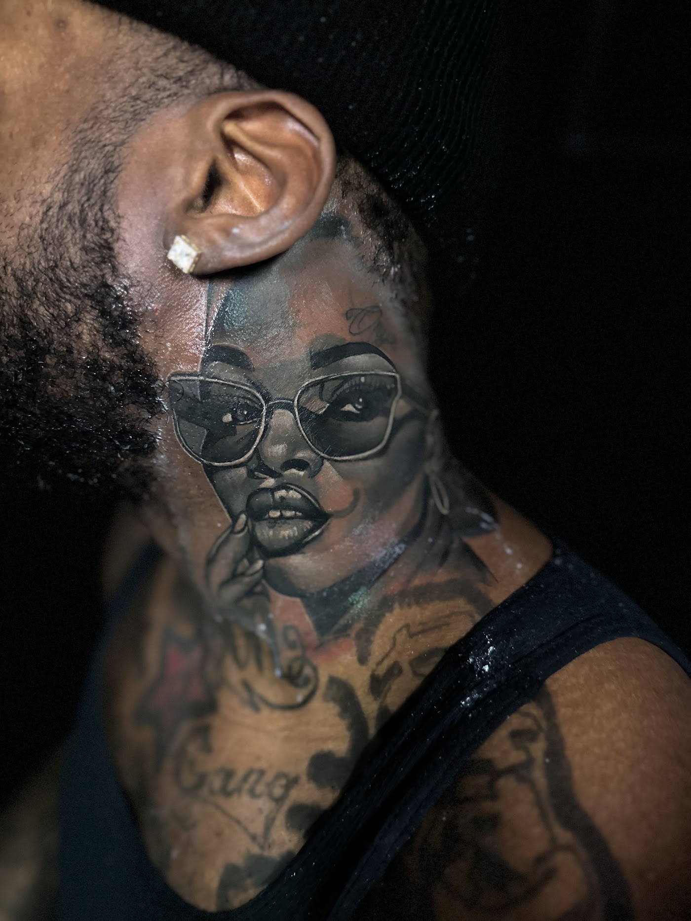 Detailed black and gray realism portrait healed on a Black client's neck, showing fine tonal range on darker skin